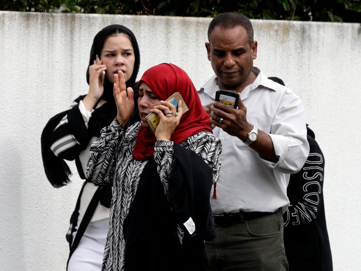 People wait outside a mosque in central Christchurch, New Zealand, on Friday. Multiple people were killed in mass shootings at two mosques full of worshippers attending Friday prayers on what the prime minister called "one of New Zealand's darkest days."