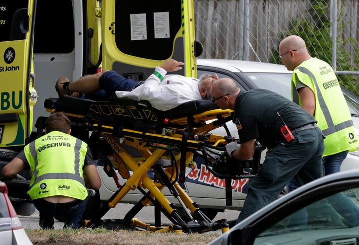 Ambulance staff take a man from outside a mosque in central Christchurch, New Zealand, on Friday.