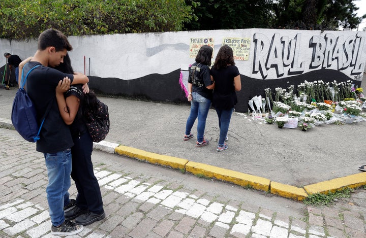 Students embrace outside the Raul Brasil state school one day after a mass shooting there in Suzano, Brazil, on March 14, 2019.