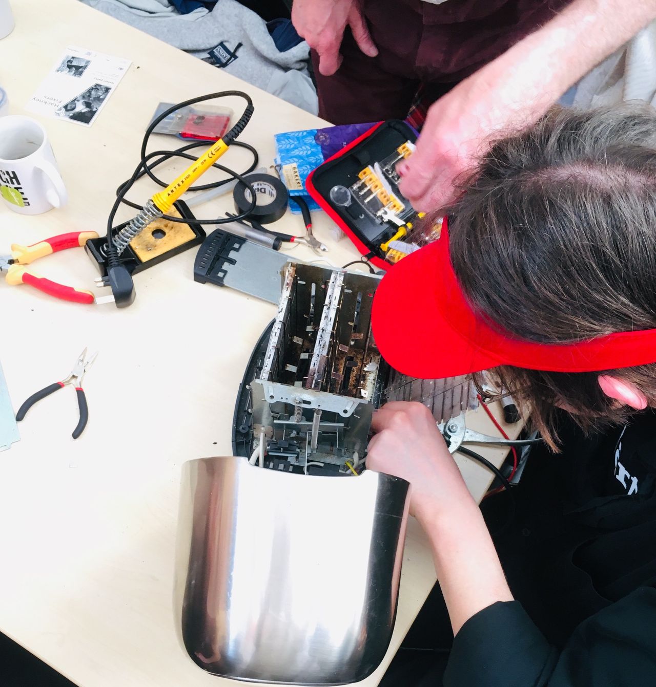 A volunteer "fixpert" assesses a broken toaster at the repair event I went to in London. The aim isn't just to fix the appliance but to share repair skills and confidence with its owner.