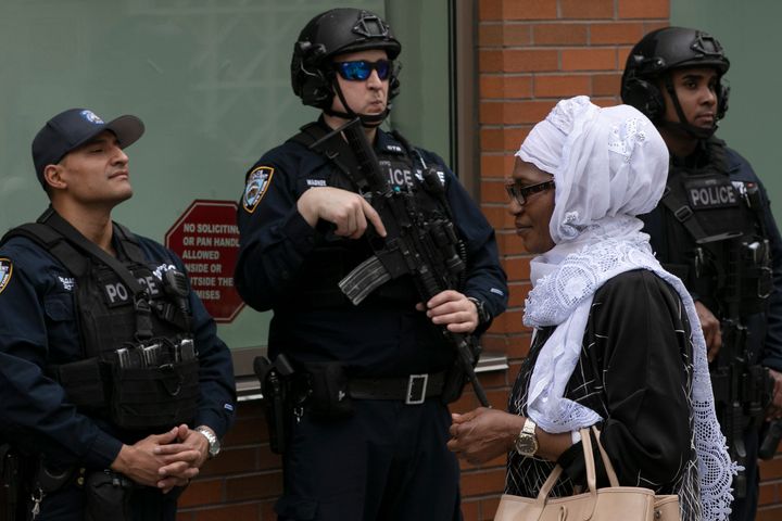 A woman leaves the Islamic Cultural Center of New York under increased police security following the shooting in New Zealand on March 15, 2019.