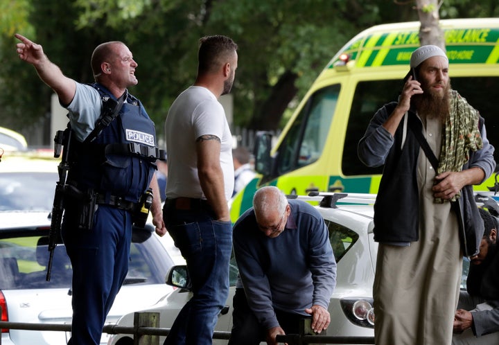 Police attempt to clear people from outside a mosque in central Christchurch, New Zealand, amid a mass shooting that claimed at least 49 lives on March 15, 2019. 