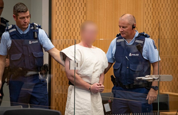 Brenton Tarrant, charged in relation to the Christchurch massacre, is escorted in the courtroom Saturday in Christchurch, New Zealand.