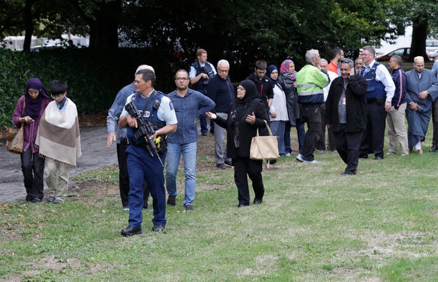 Police escort people after the