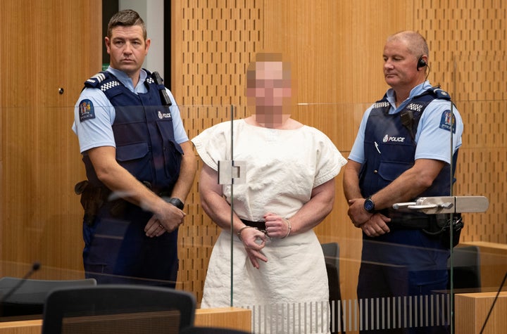 The suspect made a sign to the camera during his appearance in the Christchurch District Court on Saturday.