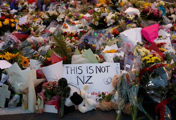 Mourners place flowers as they pay their respects at a makeshift memorial near the Masjid Al Noor mosque in Christchurch, New Zealand, Saturday, March 16, 2019. (AP Photo/Vincent Yu)