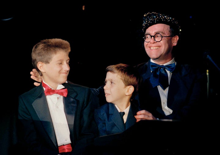 AIDS activist Ryan White is seen far left of British pop singer Elton John at the "For the Love of Children" benefit for children with AIDS and other serious illnesses in Los Angeles in 1988.