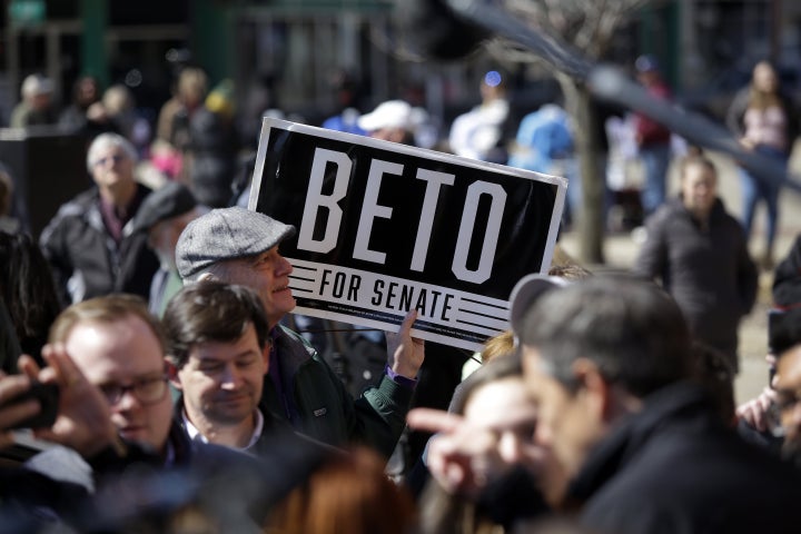 An attendee holds a sign for O'Rourke during the Eric Giddens event.