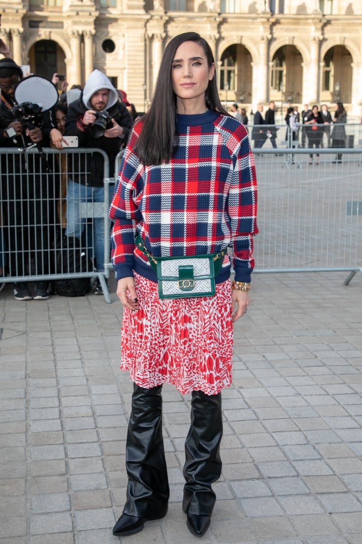 Jennifer Connelly wears a skirt over pants outside the Louis Vuitton show in Paris, 2019.