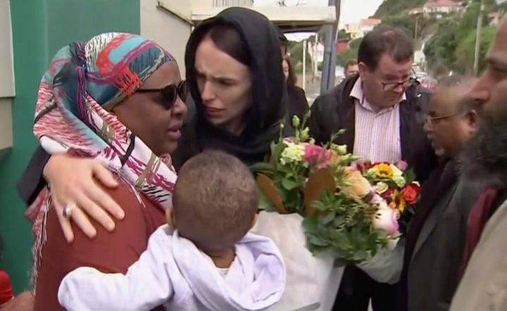 In this image made from video, New Zealand's Prime Minister Jacinda Ardern, center, hugs and consoles a woman as she visited Kilbirnie Mosque to lay flowers among tributes to Christchurch attack victims, in Wellington, Sunday, March 17, 2019.