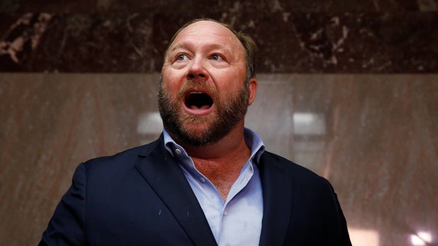 Radio host Alex Jones of Infowars talks to the news media as he arrives to listen to the testimony of Twitter CEO Jack Dorsey and Facebook COO Sheryl Sandberg at a Senate Intelligence Committee hearing on foreign influence operations on social media platforms on Capitol Hill in Washington, U.S., September 5, 2018. REUTERS/Jim Bourg
