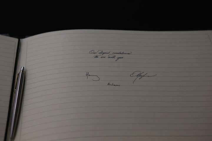 Harry and Meghan's signatures in the book of condolences. 