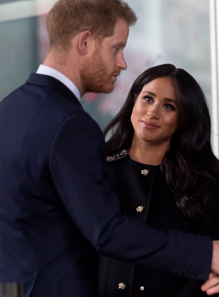 Meghan looks up at Harry during the stop on Tuesday.