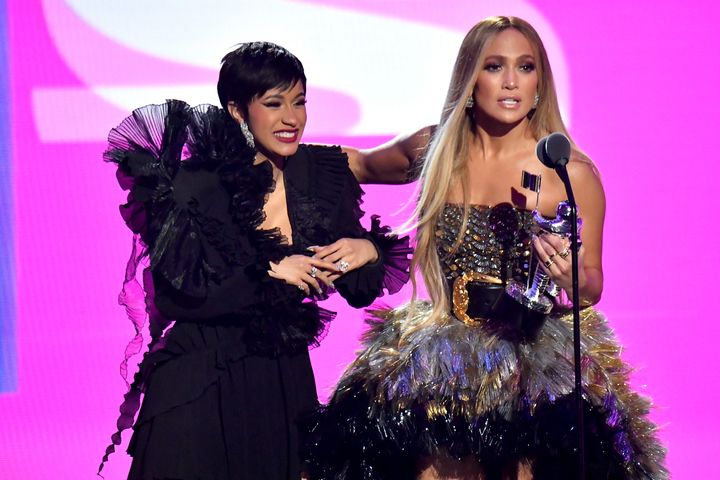 Cardi B and Jennifer Lopez accept an award together at the 2018 MTV Video Music Awards. 