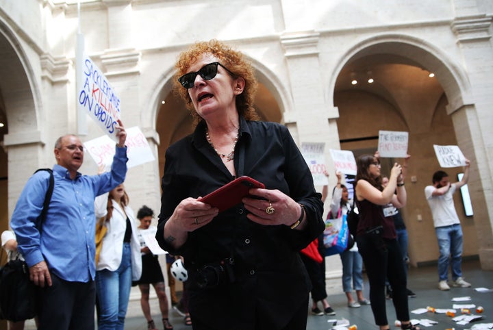 Photographer Nan Goldin leads a demonstration at the Harvard Art Museums in Cambridge, MA on July 20, 2018 to protest the ben