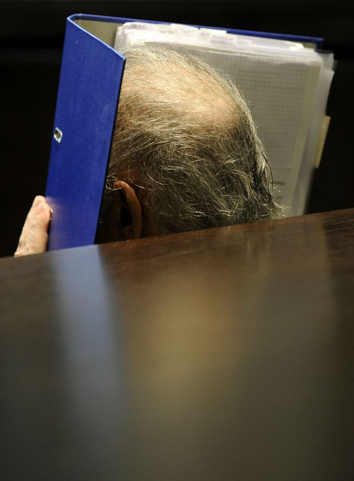 Frizl covering his face during his trial in 2009 