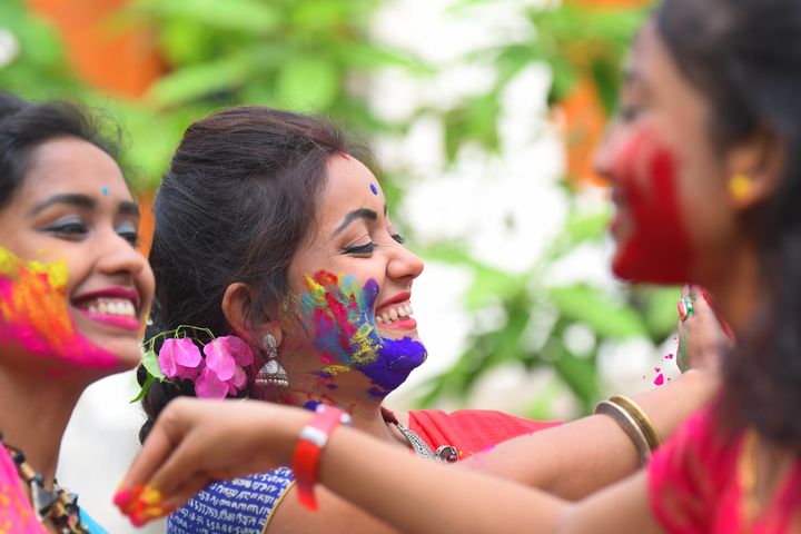 Women play with colours in Agartala. 