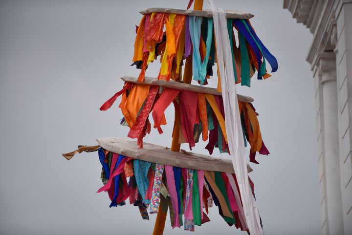 A ceremonial bamboo log known as "chir" is erected in Kathmandu's Basantapur Durbar Square to mark the beginning of Holi. The coloured strips of cloth on the stick are considered goodluck charms. 