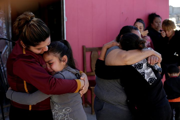 A woman in Ciudad Juarez, Mexico, embraces the daughter of Perez, a Mexican migrant who died at a Texas hospital on Monday.