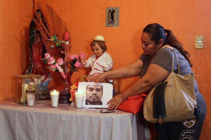 Sandra Perez places a photo of her late brother, Rene Pablo Perez, at an altar in her home in Ciudad Juarez, Mexico, on Tuesday.