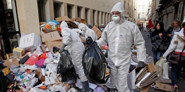 Security civil members requisitioned by French government clean the streets and piled up garbage in Marseille...