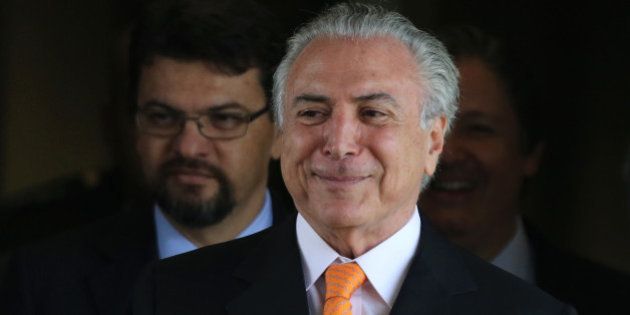 Brazilâs Vice President Michel Temer talks with journalists as he leaves his office at Planalto presidential...
