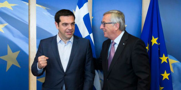 Greek Prime Minister Alexis Tsipras, left, is greeted by European Commission President Jean-Claude Juncker...