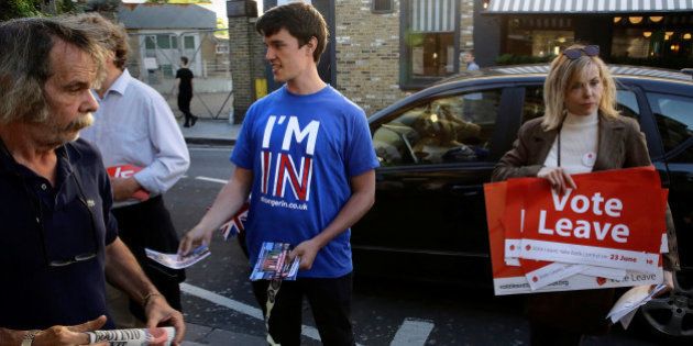 A Britain Stronger In Europe campaigner (L) stands next to a Vote Leave campaigner outside Parsons Green...