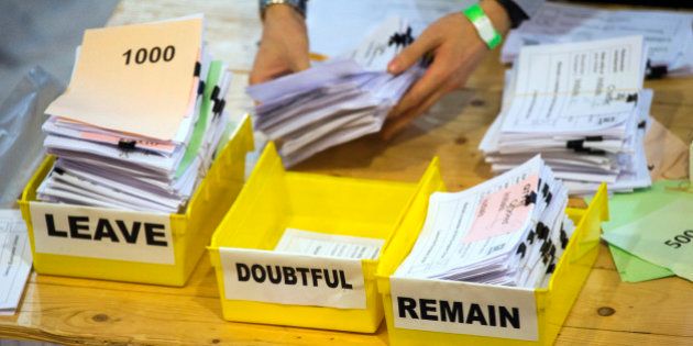 FILE - In this Friday, June 24, 2016 file photo, votes are sorted into remain, leave and doubtful trays...