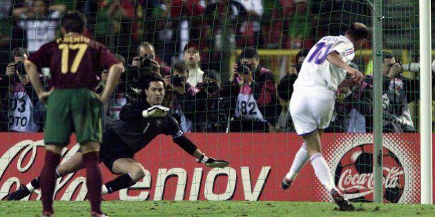 France's Zinedine Zidane (R) scores his extra time golden penalty goal against Portugal's goal keeper...