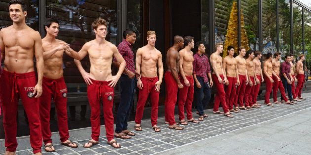 The shirtless Abercrombie and Fitch models posed in front of the American fashion chain's flagship store...