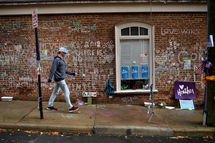 Messages in chalk fill a brick wall where Heather Heyer was killed on Heather Heyer Way, at the Downtown Mall in Charlottesville, Va., on Aug. 11, 2018. 