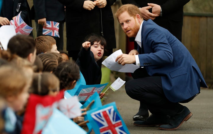 The Duke of Sussex speaks to 6-year-old Stella, a pupil at St. Vincent's Catholic Primary School.