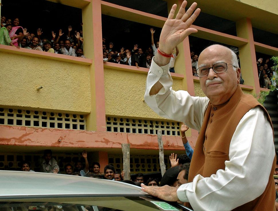 L.K. Advani waves as he comes out of a district court in Rae Bareli on July 28, 2005.