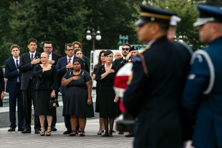 The family of Sen. John McCain (R-Ariz.) front row from left, Meghan McCain, Bridget McCain and Cindy McCain, watches as his casket is carried to a hearse from the U.S. Capitol in Washington, D.C., on Sept. 1, 2018.