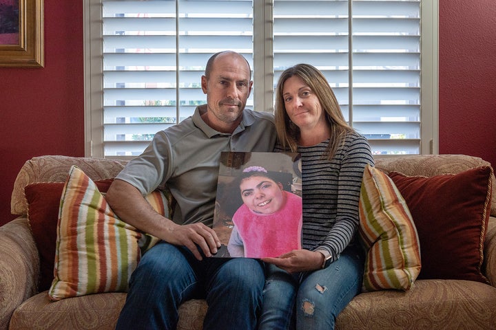 Bobby and Tara Dilliplaine hold a photo of daughter Brooke, who suffered complications when she was given medication she was