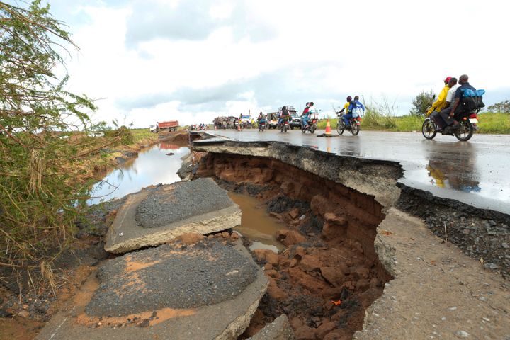 Motorcycles pass through a section of road damaged by Cyclone Idai in Nyamatanda about 50 kilometres from Beira, in Mozambique, Thursday March, 21, 2019. 