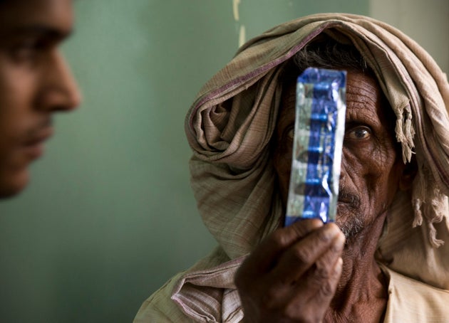 A tuberculosis patient holds medicines at the Lal Bahadur Shastri Government Hospital at Ram Nagar in...