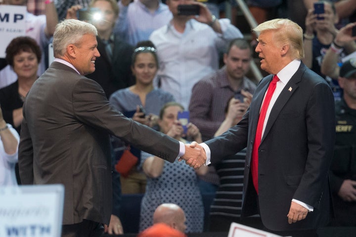 Buffalo Bills head coach Rex Ryan shakes hands with Donald Trump after introducing him during a campaign stop in Buffalo, New York, on April 18, 2016.