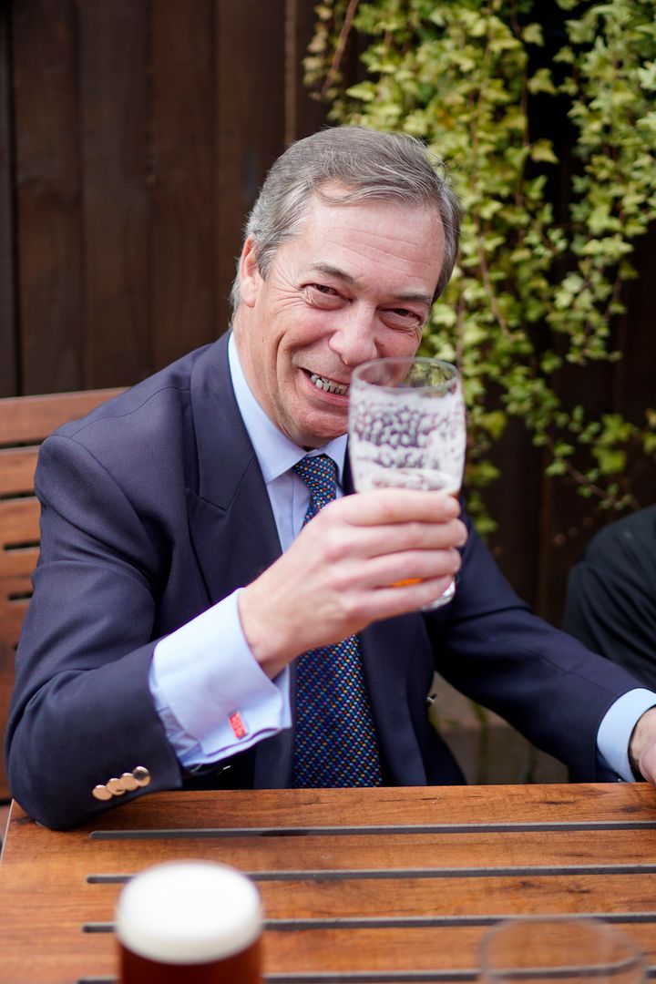 Farage wears 'Keep Calm and Carry ON' cufflinks as he drinks a pint of beer at the Last Post pub at the end of the 'March to Leave' walk from the village of Linby to Beeston, Nottinghamshire.