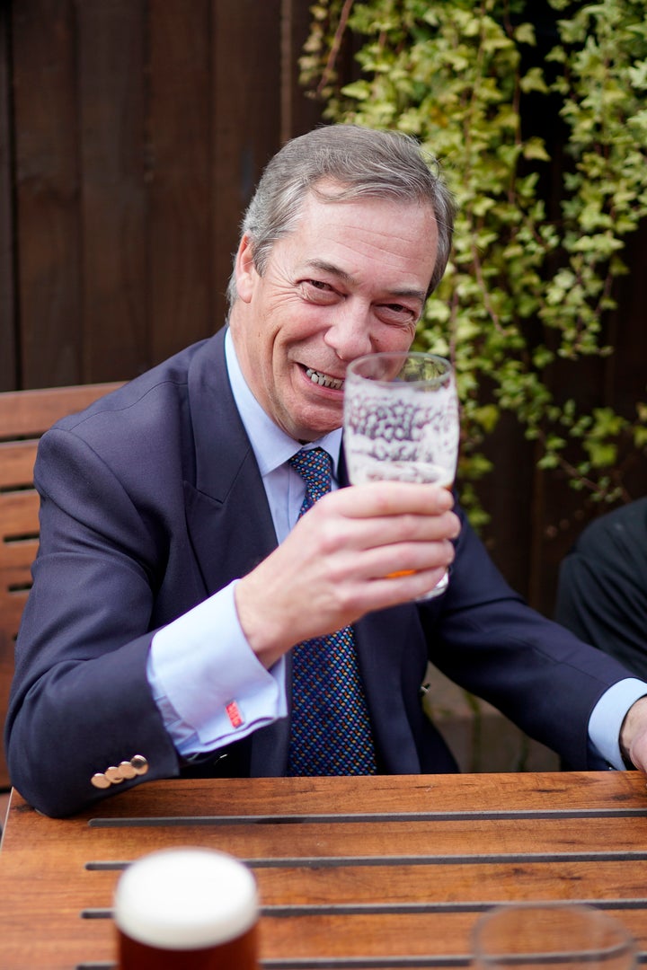 Farage wears 'Keep Calm and Carry ON' cufflinks as he drinks a pint of beer at the Last Post pub at the end of the 'March to Leave' walk from the village of Linby to Beeston, Nottinghamshire.