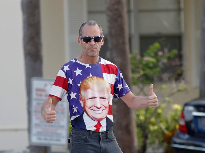 A supporter give a thumbs up before the motorcade carrying President Donald Trump passes by on Sunday, March 24, 2019, in West Palm Beach, Fla. (