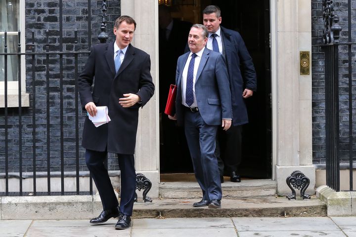 Foreign Secretary Jeremy Hunt and Trade Secretary Liam Fox leave cabinet