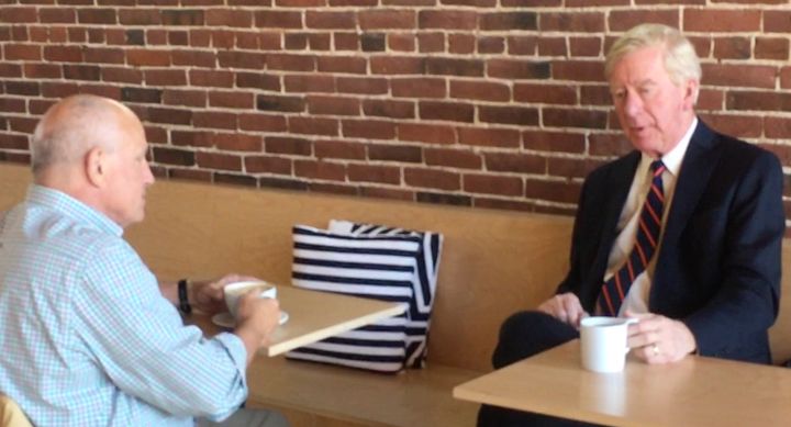 Former Massachusetts Gov. Bill Weld, right, chats Monday about his Republican primary challenge to President Donald Trump over coffee in Concord, New Hampshire.