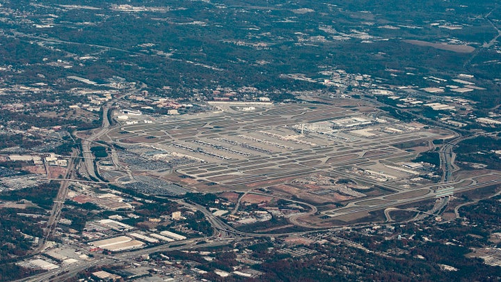 People search around the airport, which covers more than 4,000 acres of fields