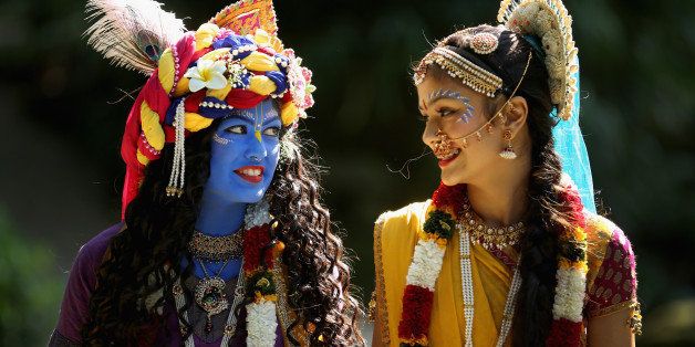 WATFORD, ENGLAND - AUGUST 28: Laxmipriya Patel (L), aged 20, dressed as the Hindu god Lord Krishna, and her sister Mohini Patel, aged 13, dressed as Lord Krishna's devotee Radharani, walk through the George Harrison Memorial Garden during the Janmashtami Hindu Festival at Bhaktivedanta Manor on August 28, 2013 in Watford, England. Up to 72,000 were expected to take part in the Hindu festival of 'Janmashtami', which falls on August 28 this year, and marks the birth of the Hindu god Lord Krishna. The festival is believed to be the largest Hindu festival gathering outside of India. Bhaktivedanta Manor is also celebrating it's 40th year since the manor house was donated to the Society of Krishna Consciousness by George Harrison in 1973. (Photo by Christopher Furlong/Getty Images)