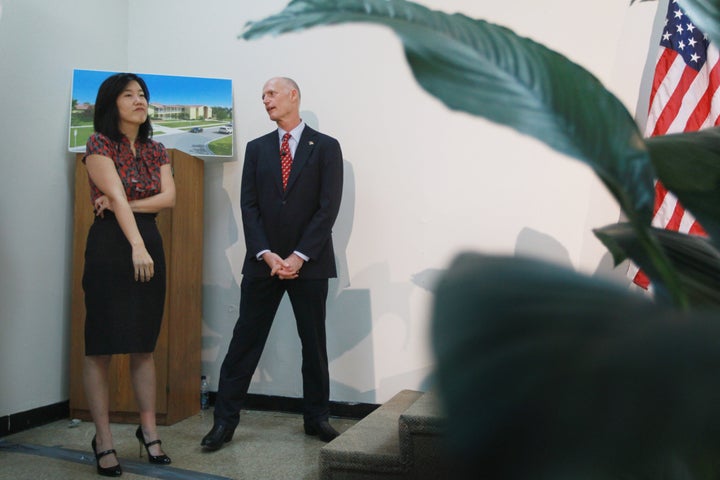 OPA LOCKA, FL - JANUARY 06: Florida Gov. Rick Scott (R) stands with Michelle Rhee, who was named as the Informal Education Advisor to the Governor, as they wait to be introduced during a visit to the Florida International Academy charter school on January 6, 2011 in Opa Locka, Florida. Gov. Scott announced yesterday that Rhee, who is the former head of public schools in Washington, D.C., will now serve the governor as the Informal Education Advisor to the Governor. (Photo by Joe Raedle/Getty Images)