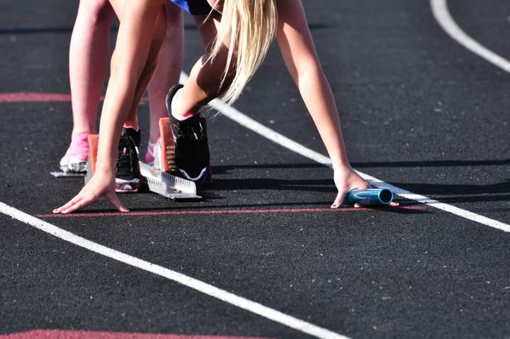 Teen Girl in the Starting Blocks at a Track Meet