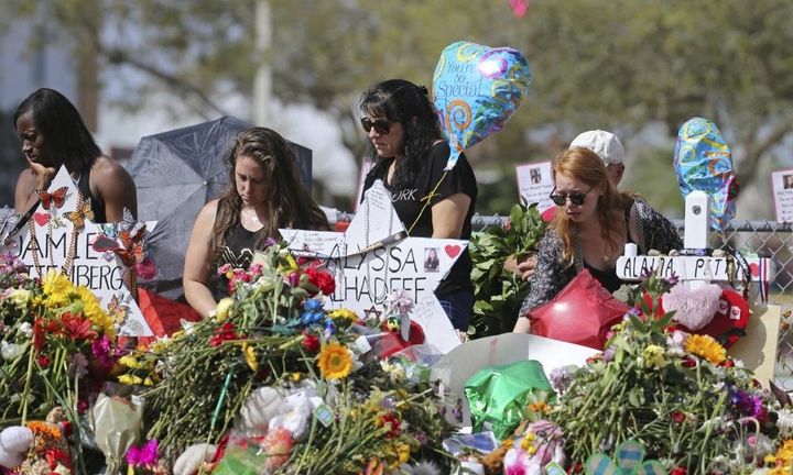 A makeshift memorial for victims of the shooting at Marjory Stoneman Douglas High School in Parkland, Florida, in February 2018. After a mass shooting, community members' trauma lingers months or years after media attention fades.