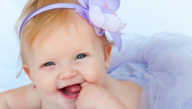 Portrait of a beautiful baby girl wearing a purpule ballet tutu